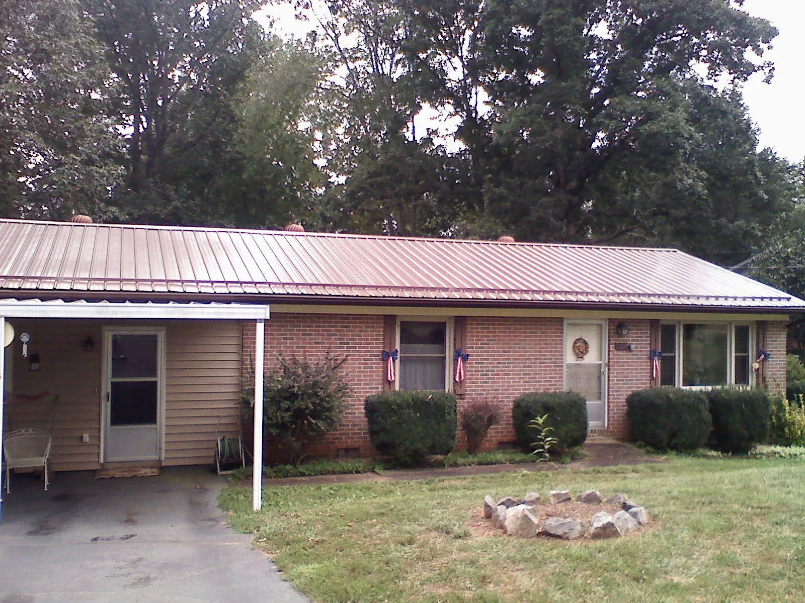 Bronze metal roof and carport on a brick ranch home — Roof Repair work by our crew in Scranton