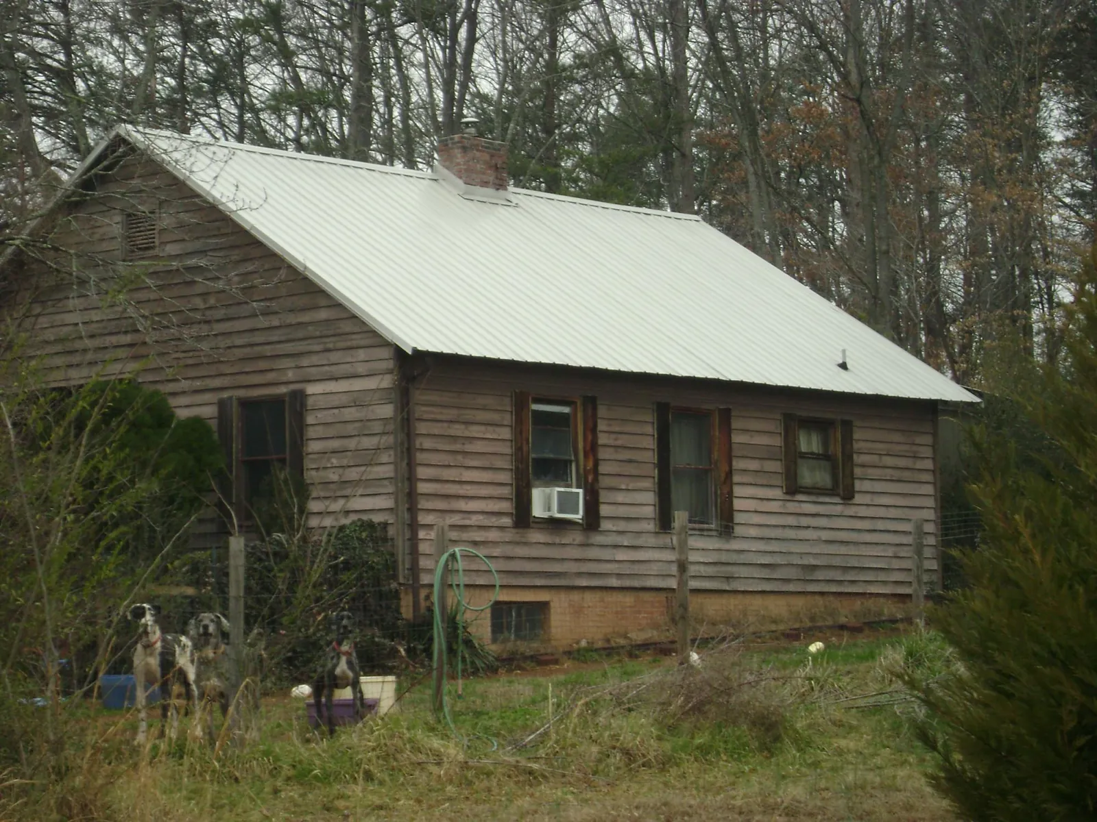 White metal roof on an old wood sided farmhouse, from a Metal Roof Installation job in Scranton